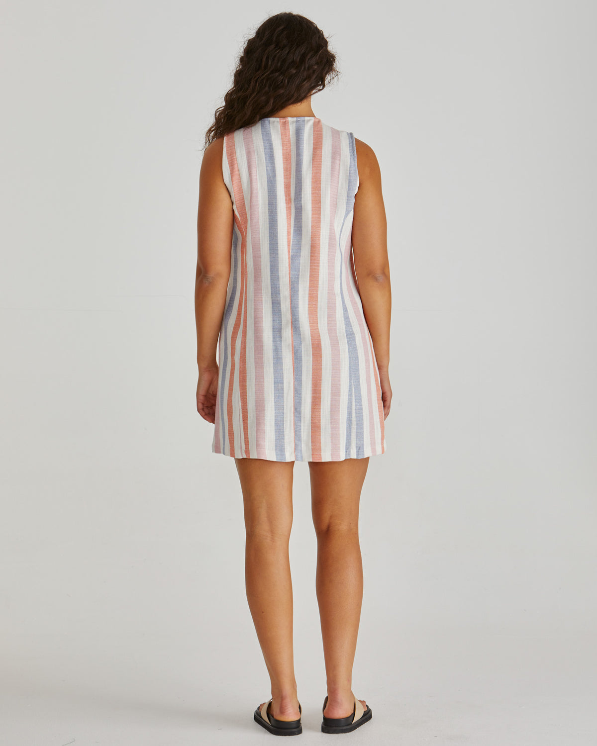 Back View of Lady wearing the SASS Travis Vest Dress in stripe with princess seam detail and side pockets. Linen combination.  Available at Loloma Living, Tamborine Mountain. Stockist of SASS and Betty Basics.