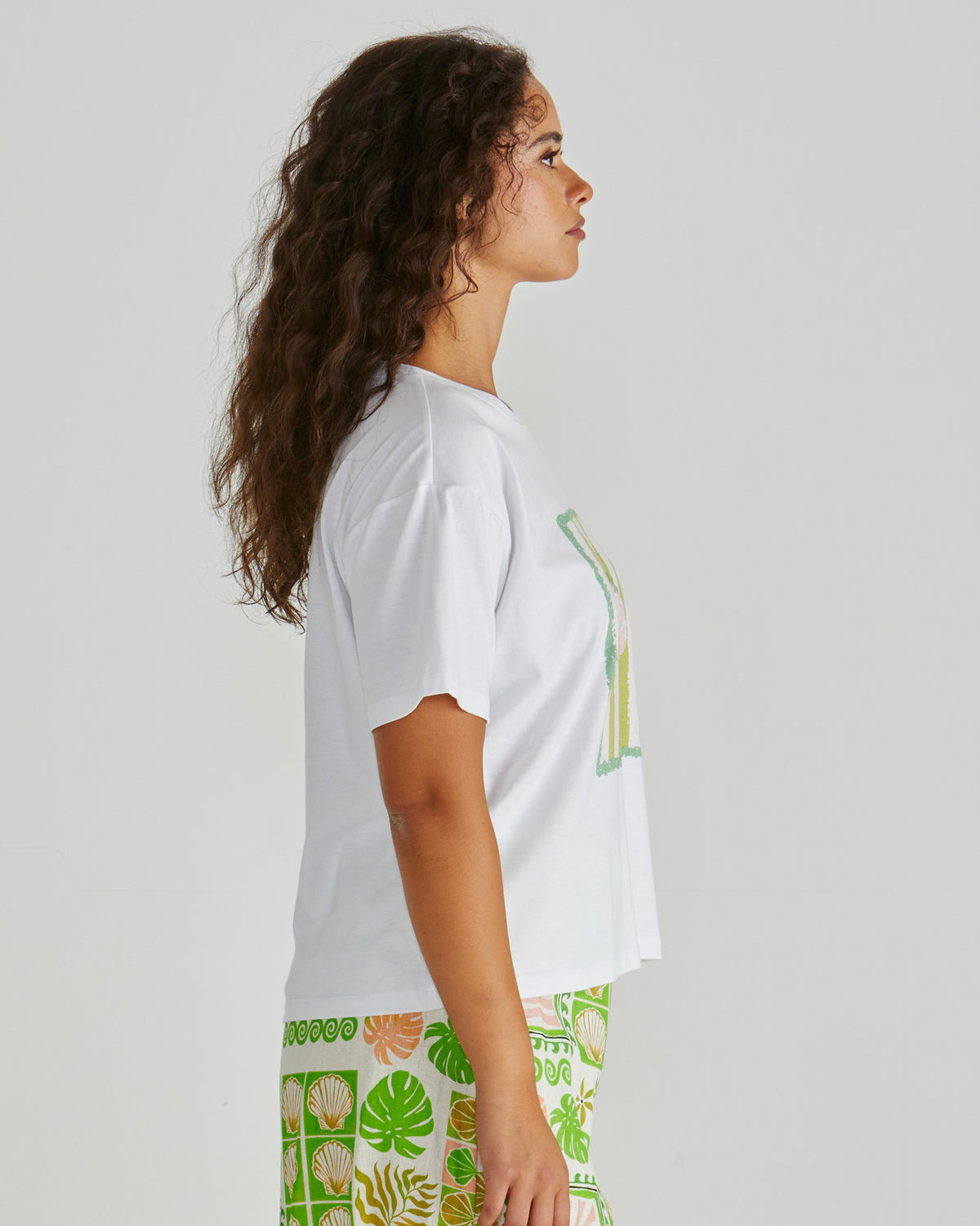 Side view of Lady wearing the SASS Cynthia Tee in exclusive seashell stripe print with dropped shoulder and soft cotton jersey. Available at Loloma Living Tamborine Mountain - stockist of SASS and Betty Basics.