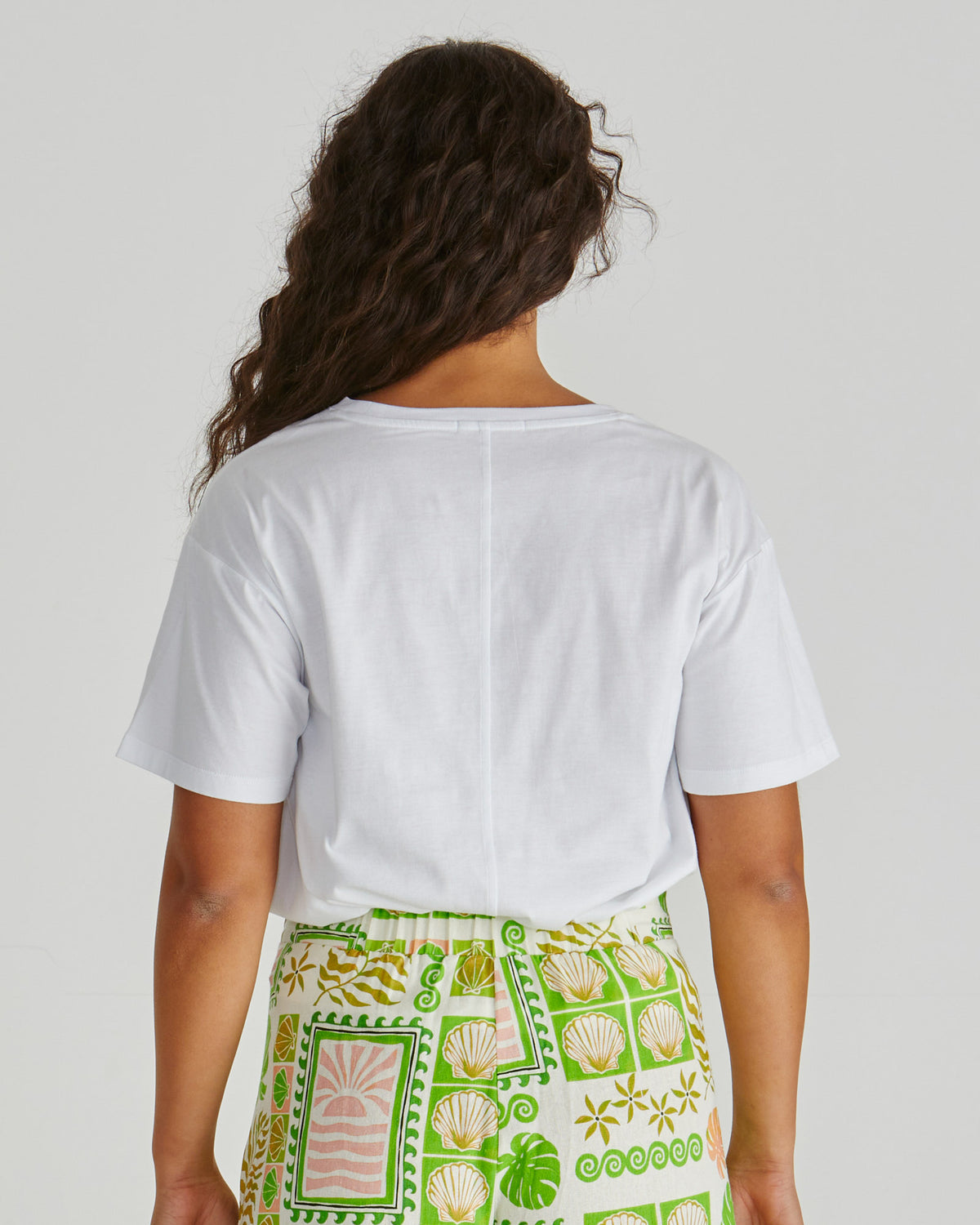 Back view of Lady wearing the SASS Cynthia Tee in exclusive seashell stripe print with dropped shoulder and soft cotton jersey. Available at Loloma Living Tamborine Mountain - stockist of SASS and Betty Basics.