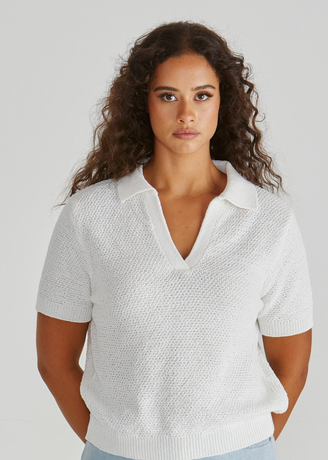 Lady wearing the Aubrie Knit Polo in White.  Giving vintage sporty style. Elegant knit top. Available at Loloma Living in Tamborine Mountain- stockist of SASS and Betty Basics.