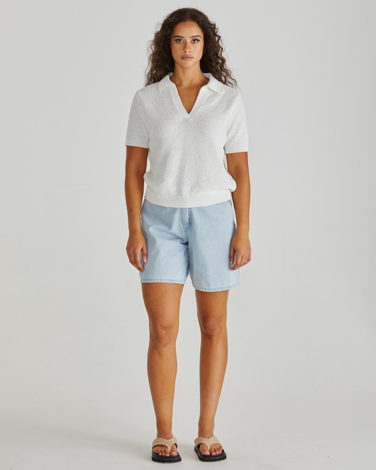 Lady wearing the SASS Aubrie Knit Polo in White.  Giving vintage sporty style. Elegant knit top. Available at Loloma Living in Tamborine Mountain- stockist of SASS and Betty Basics.