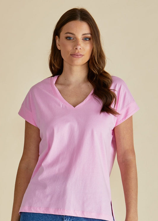 Woman wearing a pink t-shirt and blue jeans against a beige background betty basics pink tshirt stockist Loloma Living Tamborine Mountain